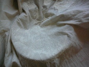 Dampen the cloth and flour it