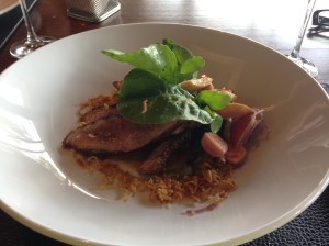 Salt and pepper crusted duck breast, peachand rocket salad