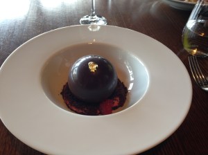 Chocolate sphere filled with mint icecream, raspberry mousse