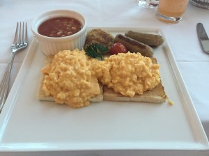 Scrambled eggs, toast, veal sausages, roesti and baked beans